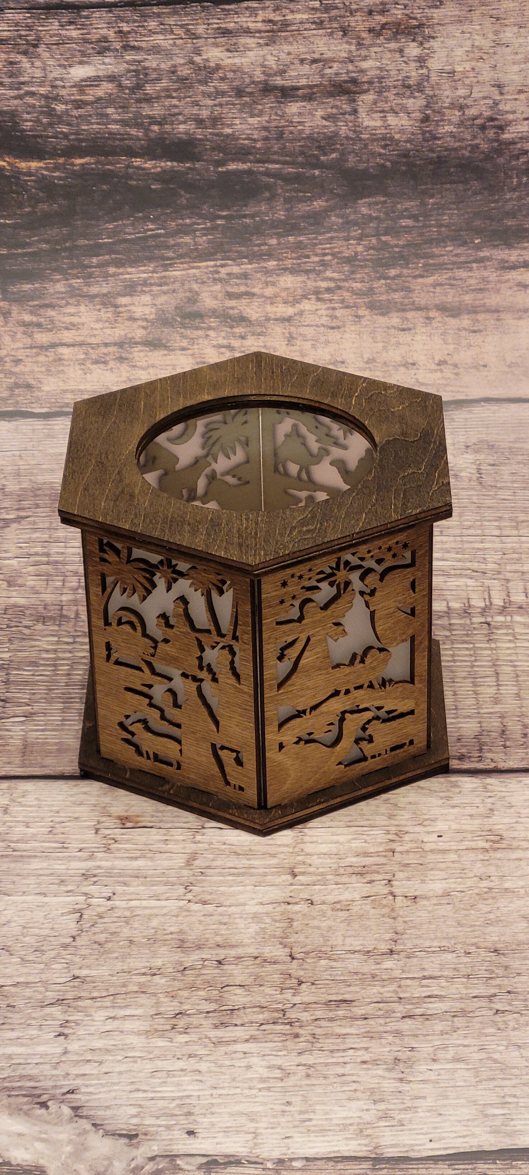 Hexagonal laser-cut wood nativity lantern with Christmas scene and natural wood grain finish