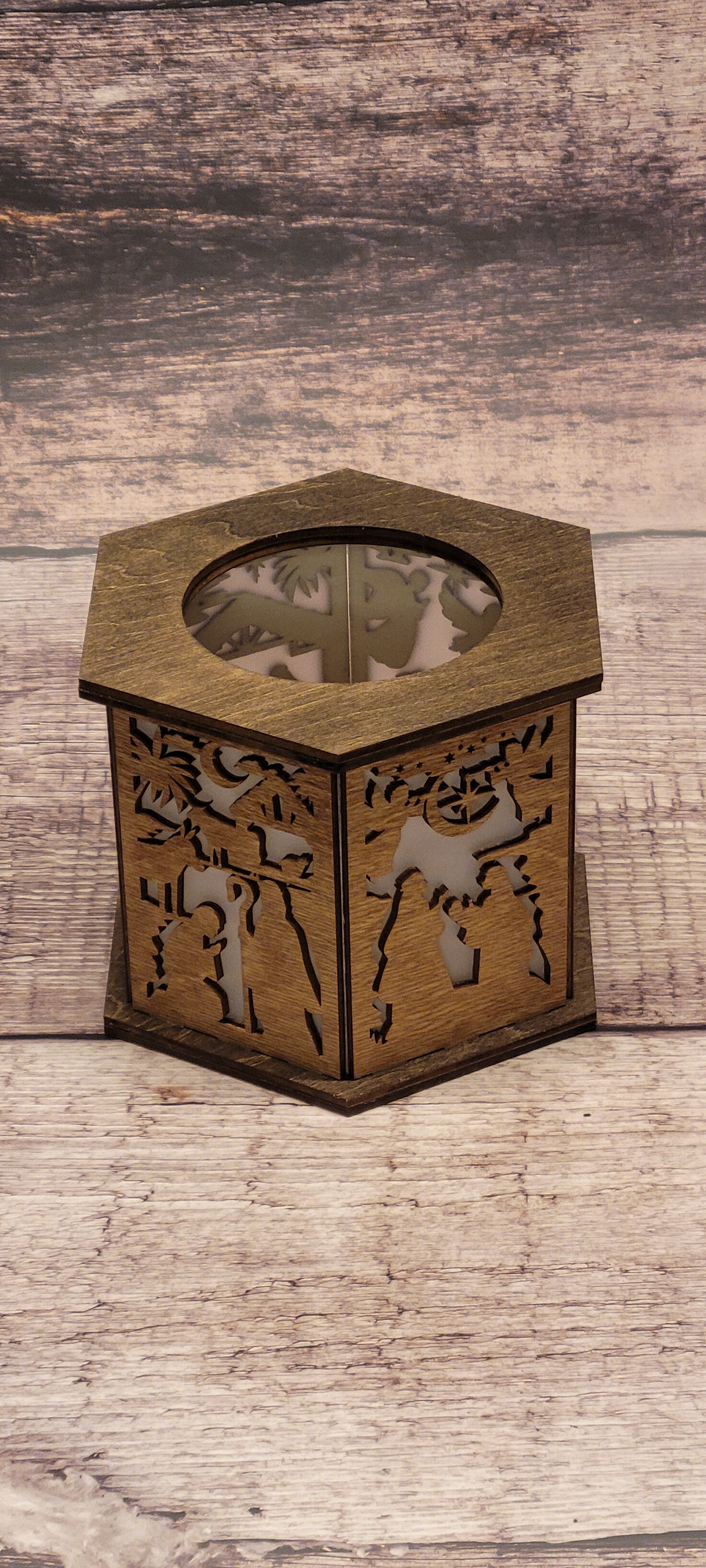 Close-up of hexagonal nativity lantern highlighting intricate laser-cut details and craftsmanship