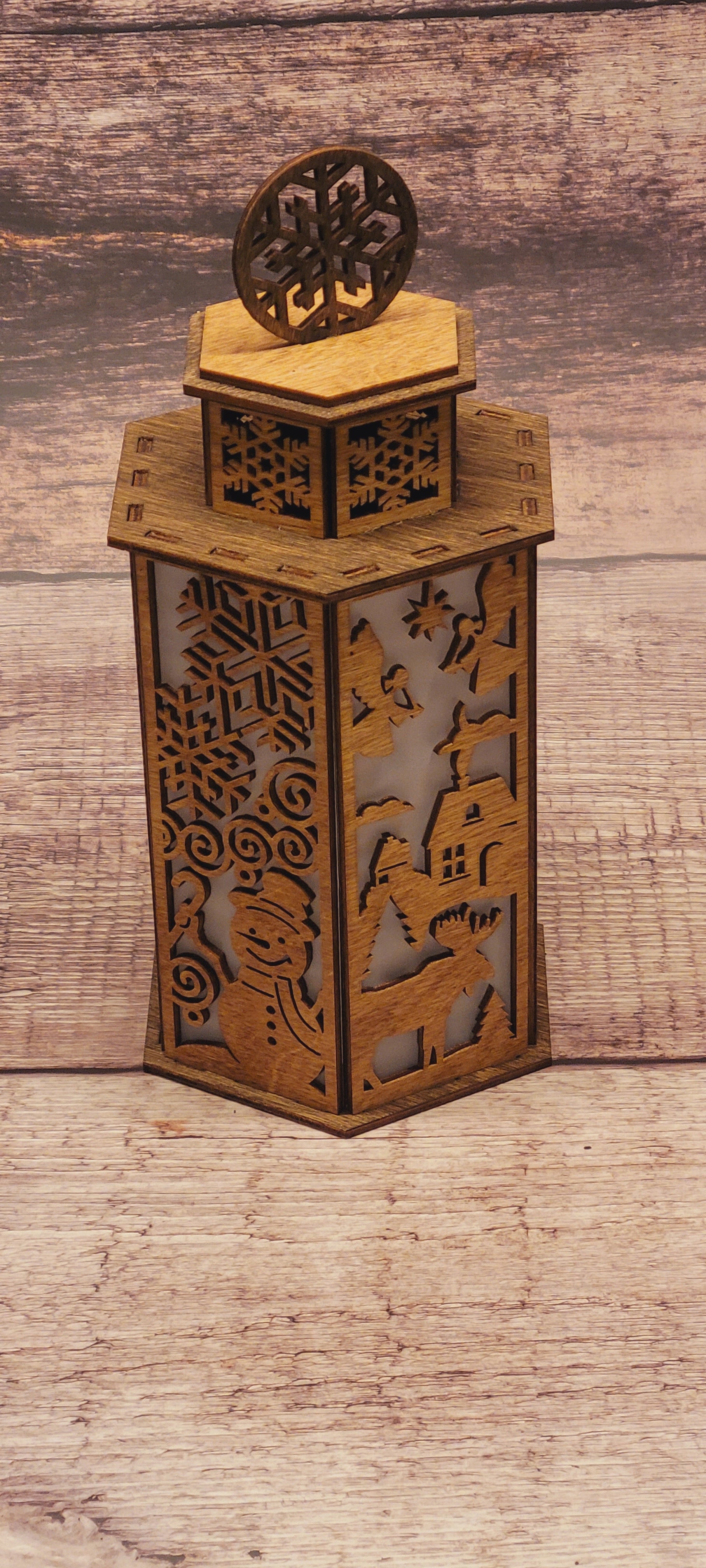 Close-up of Christmas lantern with snowflake handle showing precision laser-cut details and craftsmanship