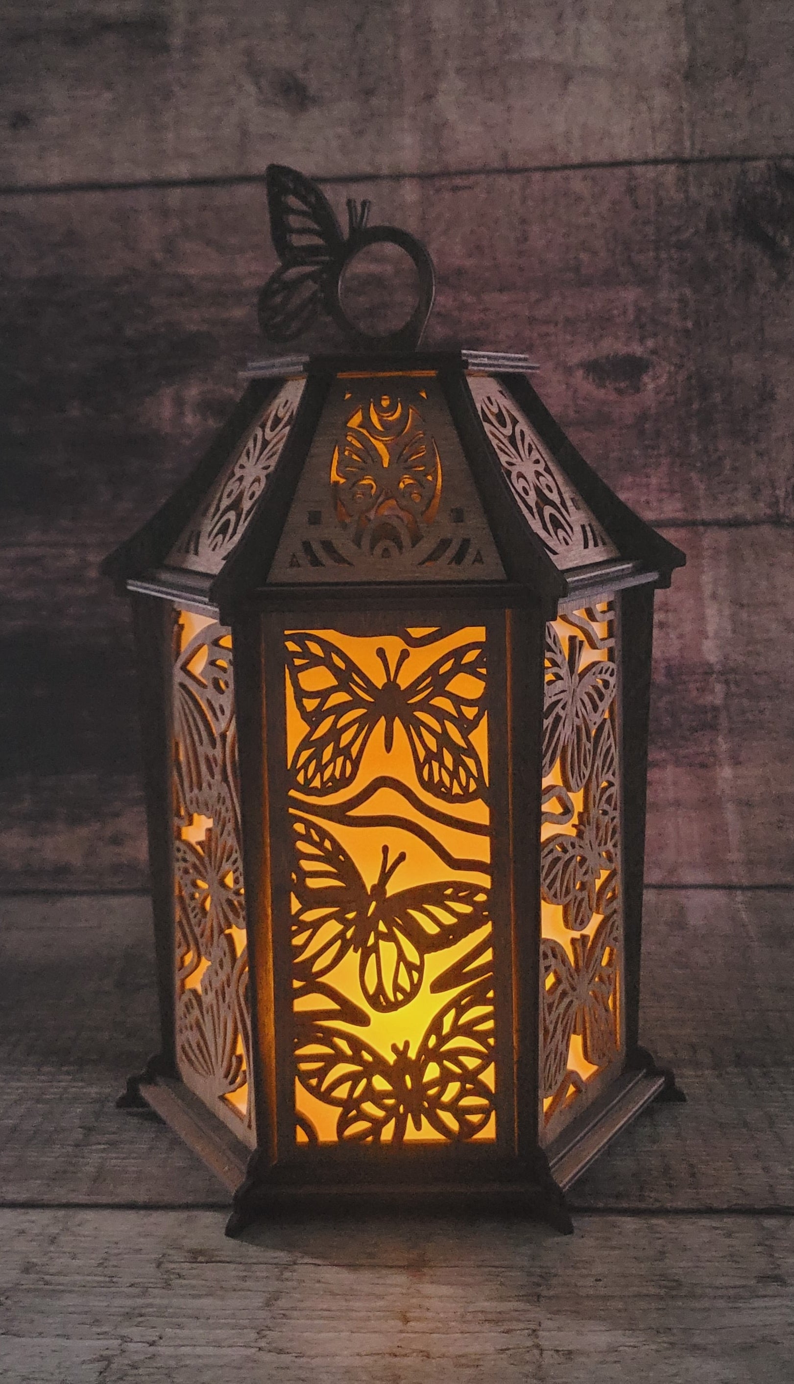 Butterfly wood lantern displaying rustic-luxury finish and decorative cutout design for ambient lighting