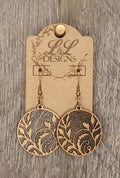 Laser-cut wood circle earrings with delicate floral vine design and rustic finish