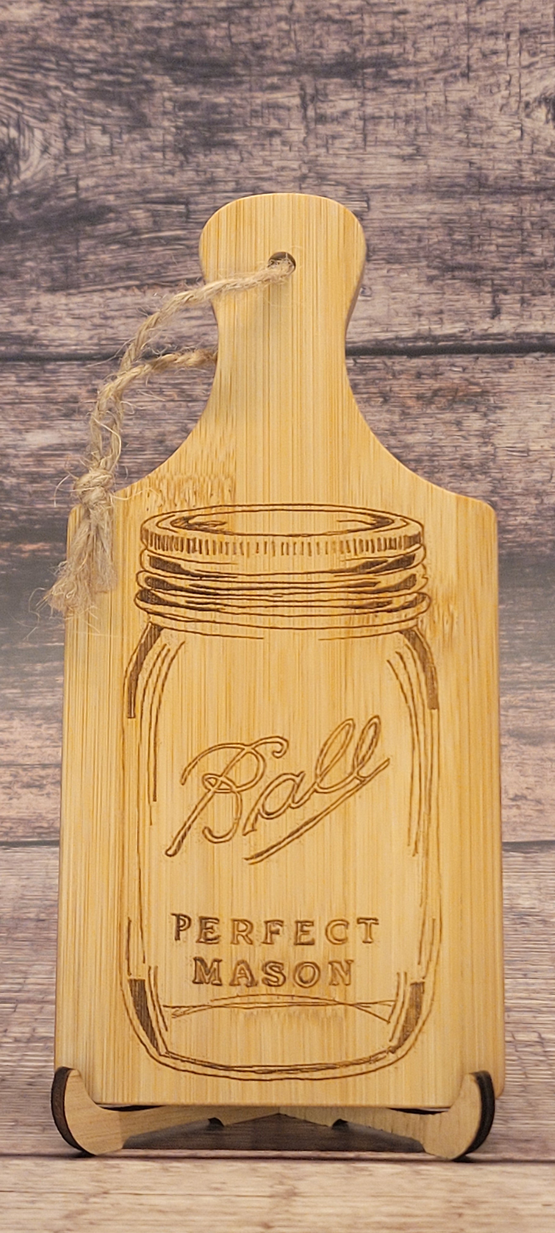 Laser-engraved bamboo charcuterie board with mason jar design and rustic finish