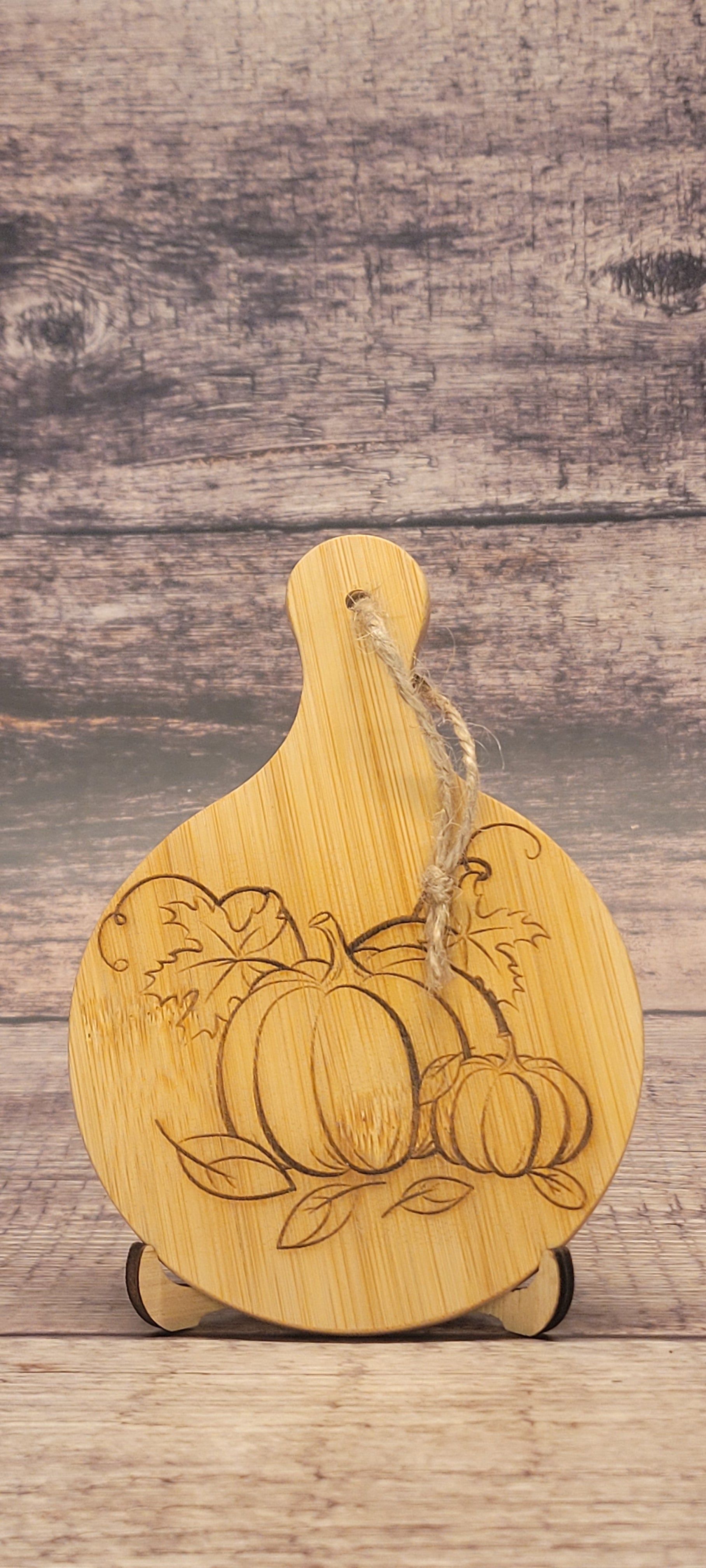 Bamboo charcuterie board with laser-engraved autumn pumpkin design and seasonal details
