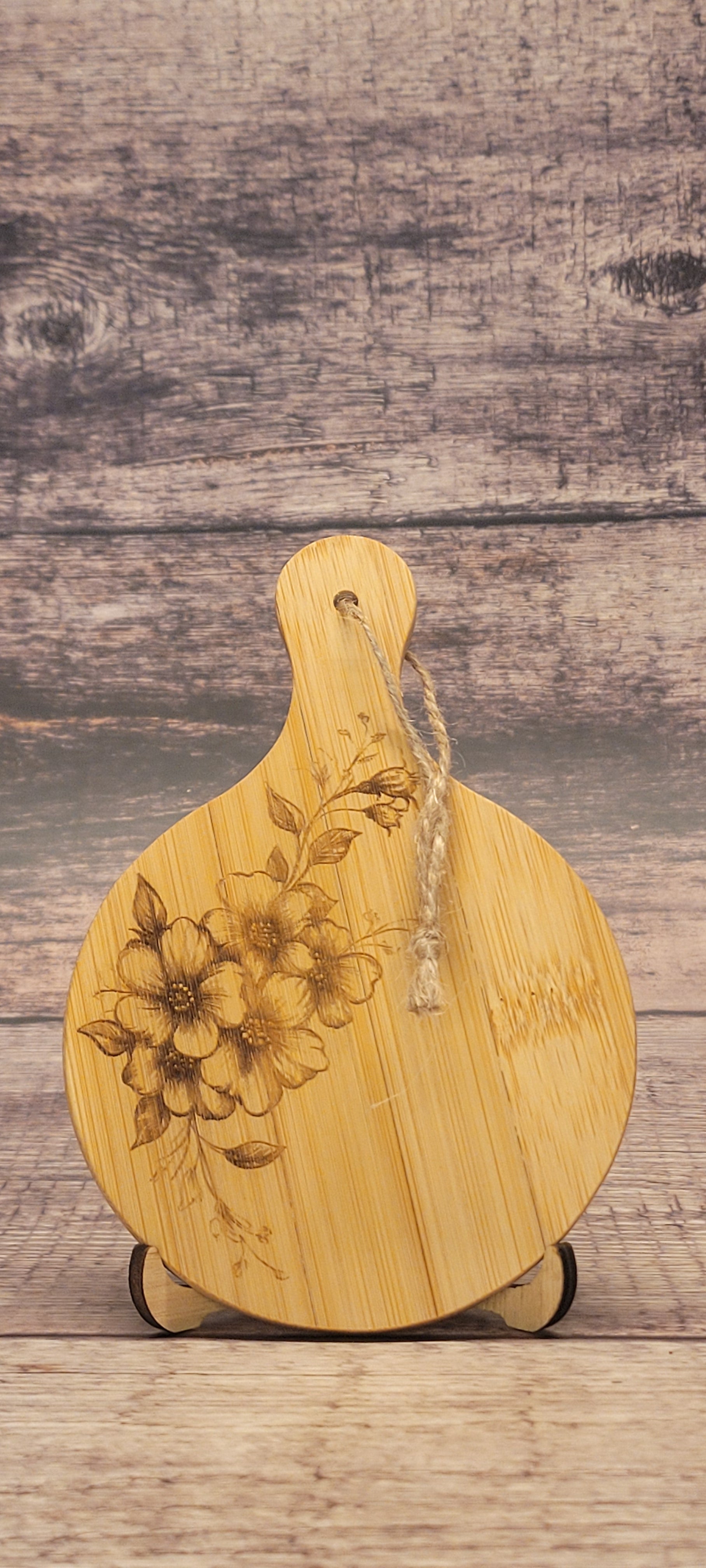 Bamboo charcuterie board featuring laser-engraved botanical floral pattern and natural finish