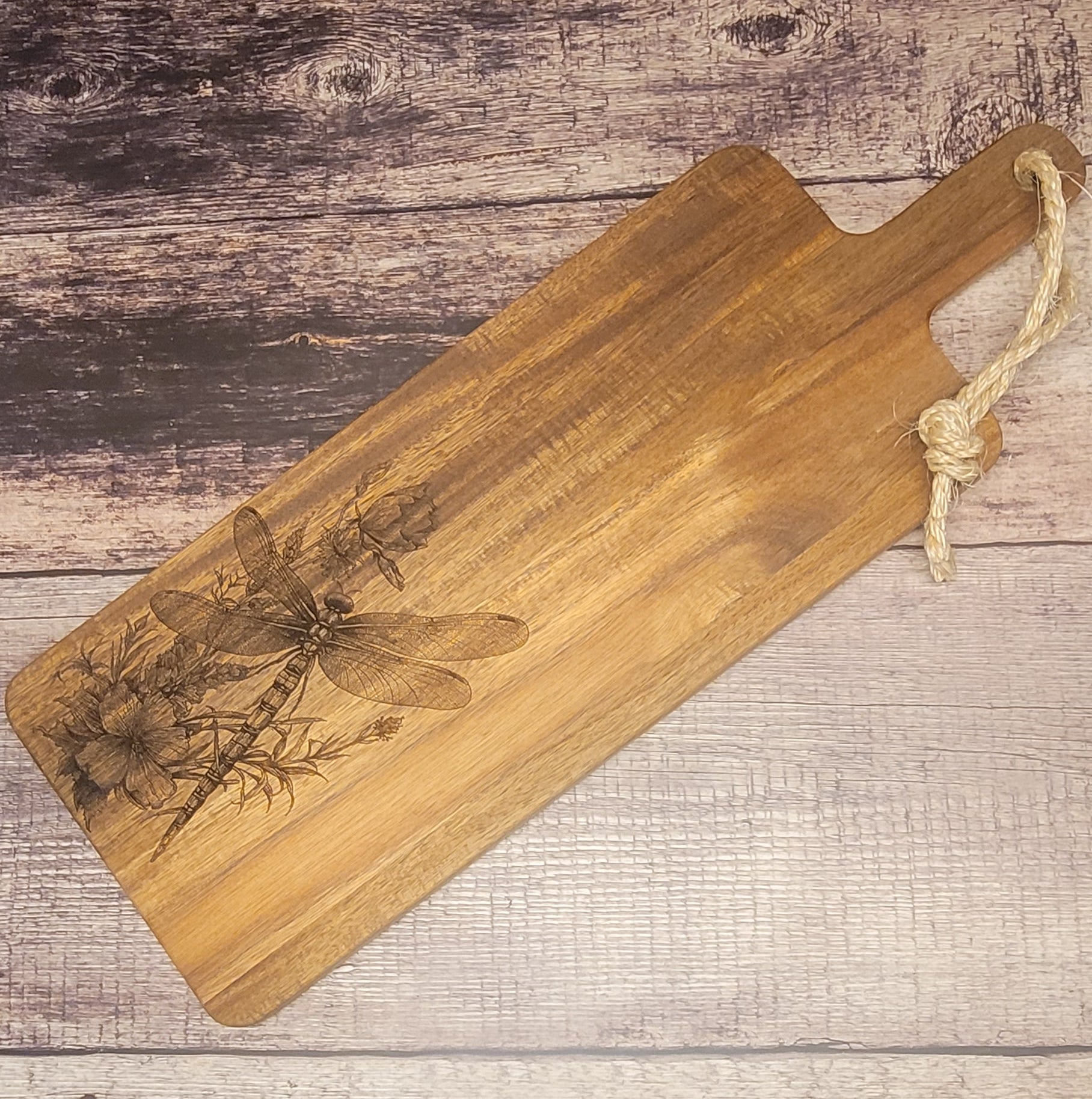 Wood serving board with laser-engraved dragonfly and wildflower design