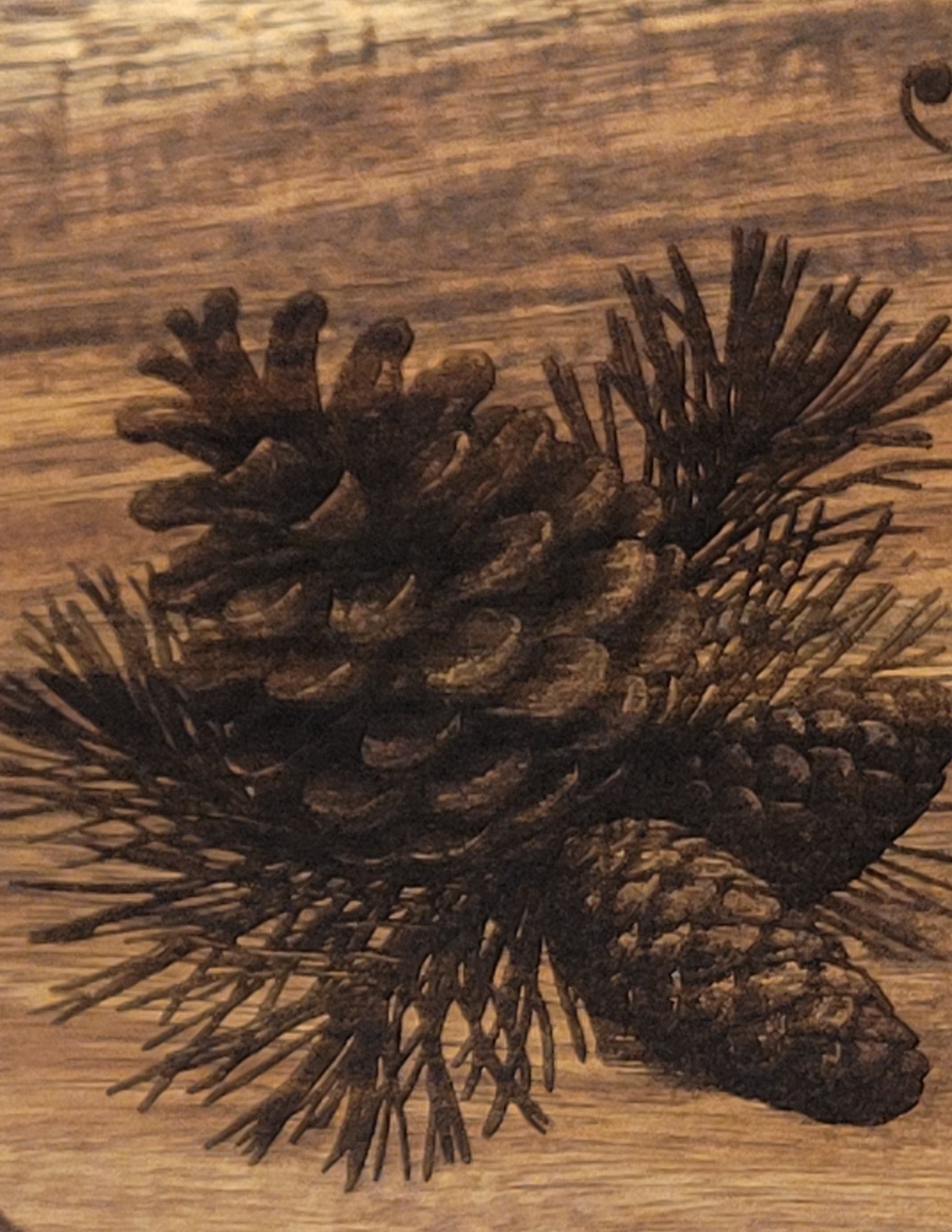 Detail of Merry Christmas serving board showing pinecone and seasonal elements
