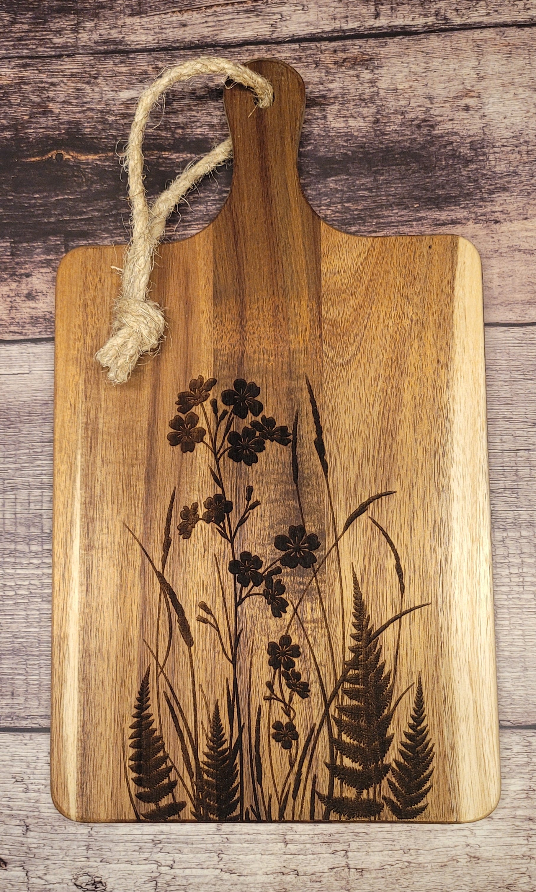 Wood serving board with laser-engraved wildflower and fern botanical design
