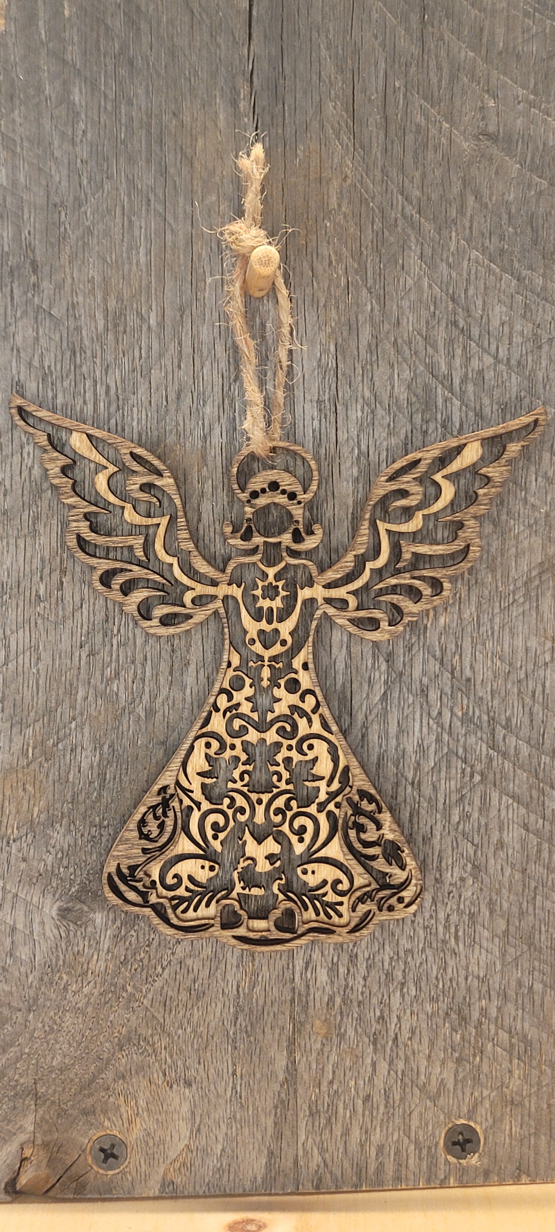 Two-tone wood angel ornament with layered filigree wings and star detail