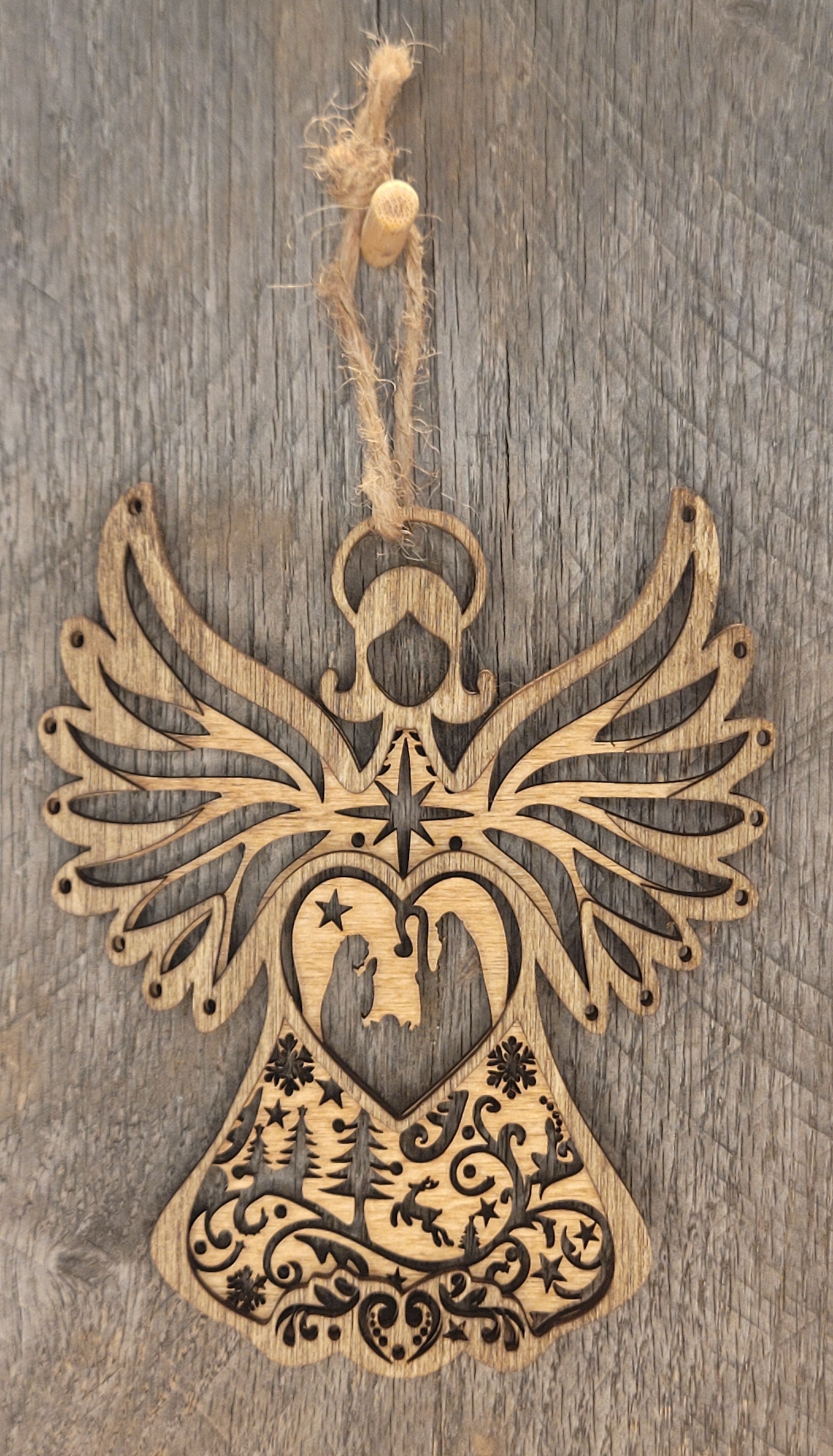 Wood angel ornament with nativity scene, starburst wings and winter landscape design